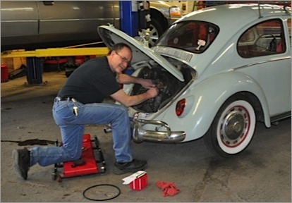 Co-owner Bill repairing a classic car
